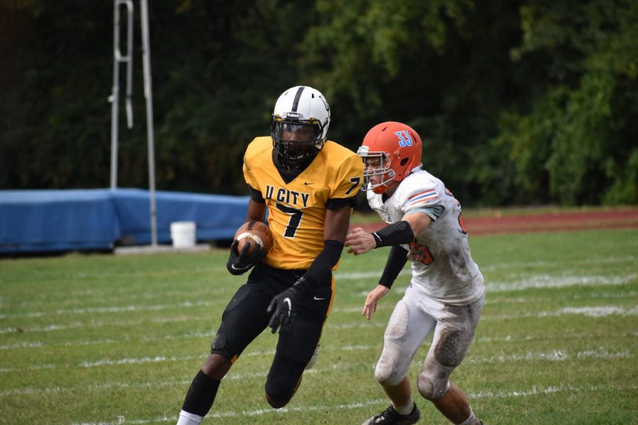 To keep the lead, Carleton Thomas, senior, tires to outrun Clayton defense. " We played as a team and didn't bring our teammates down when they made mistakes," Thomas said. 