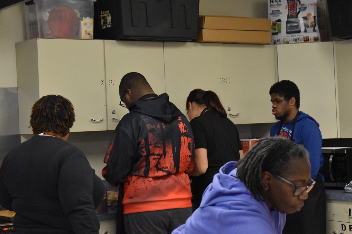 The URite students gather to serve the food they cooked. “I like doing that,” senior Joshua Henderson said. “Helping out the staff, serving the food.”