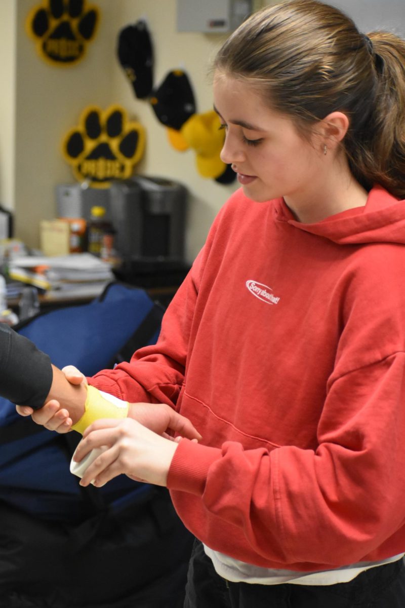 Treating an injured wrist, sophomore Inez Watt Hoven appreciates the hands-on experience the slub offers the most. "I get to learn about how the body works," Watt Hoven said, "and how there are different factors that correlate to each injury." 